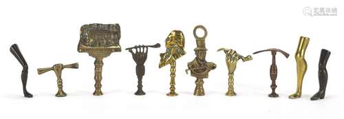 Ten antique pipe tampers including John Peel, Leg and hand design examples, the largest 8cm high :