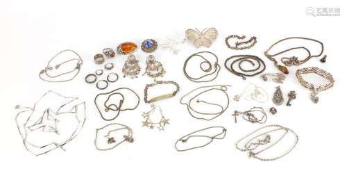 Silver and white metal jewellery including an amber brooch, filigree butterfly brooch, gate bracelet