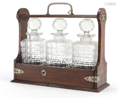 Oak three bottle tantalus with silver plated mounts, 31.5cm high : For Further Condition Reports and