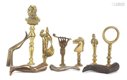 Ten antique pipe tampers including King George V, horse head and leg design examples, the largest