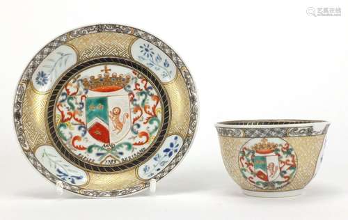 Chinese porcelain armorial tea bowl and saucer hand painted with crests and flowers, the tea bowl