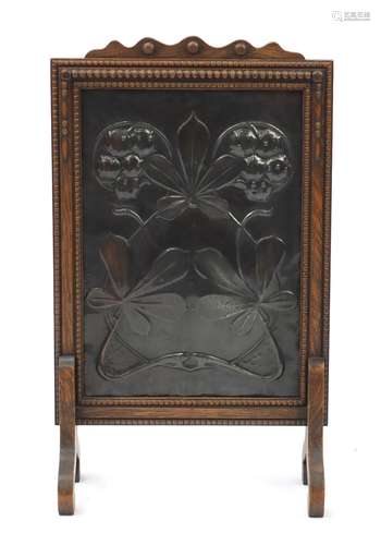 Arts & Crafts oak fire screen, the coppered panel with stylised flowers, 75cm high : For Further