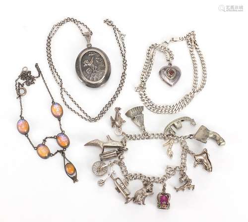 Silver and white metal jewellery including a large oval locket, charm bracelet and opalescent