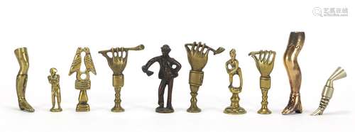 Ten antique pipe tampers including figural, leg and Napoleon design examples, the largest 7cm high :