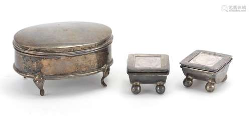 Oval silver four footed jewel box and two stamp boxes with ball feet, the jewel box Birmingham 1908,