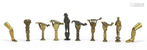 Ten antique pipe tampers including Napoleon Bonaparte, hand and leg design examples, the largest 7cm