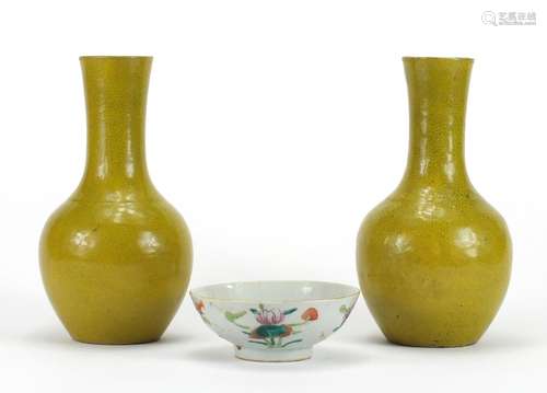 Pair of Chinese yellow glazed vases and a famille rose footed bowl hand painted with flowers, the