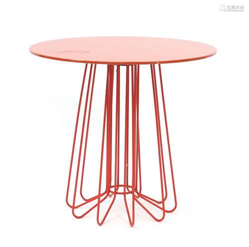 Zanotta Smallwire side table designed by Levy Arik, with circular rotating glass top in orange,