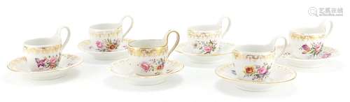 Set of six 19th century Berlin cups and saucers, each hand painted with flowers below a gilt border,