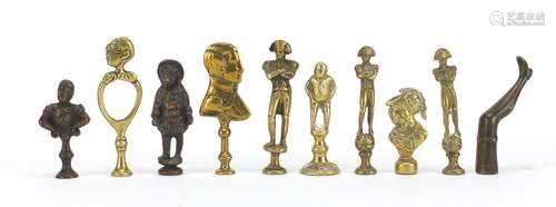 Ten antique pipe tampers including Napoleon, bust of a female and leg design examples, the largest