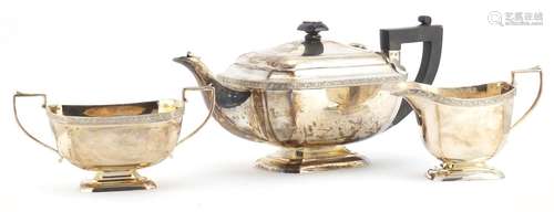 Silver three piece tea set, by John Taylor & Co, Birmingham 1938, the teapot 30cm in length,