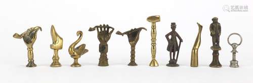 Ten antique pipe tampers including swan, figural, boot and hand design examples, the largest 6.5cm