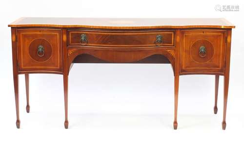 Inlaid mahogany serpentine front sideboard with brass lion mask handles, raised on tapering legs,