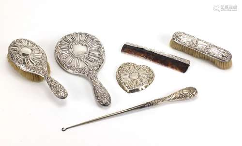 Six silver vanity items including hand mirror, brushes and heart shaped pin dish, various hallmarks,