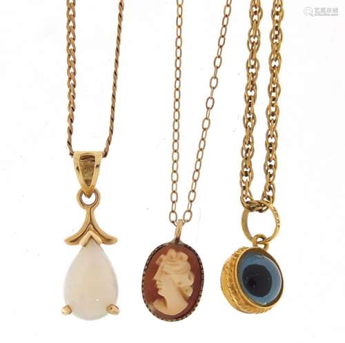 Three 9ct gold pendants on gold coloured metal necklaces including an opal, approximate weight 4.