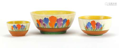 Three Clarice Cliff Bizarre bowls, each hand painted in the Crocus pattern, the largest 16.5cm in