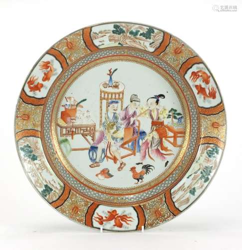 Chinese porcelain iron red shallow charger, finely hand painted in the famille rose palette with