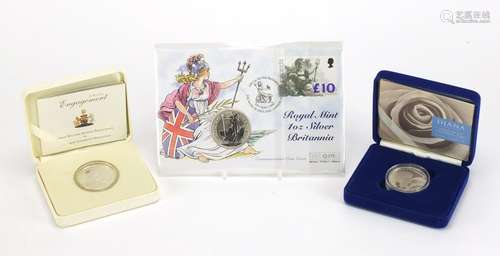 Two silver proof commemorative crowns and a 1998 one ounce silver Britannia coin cover, the crowns