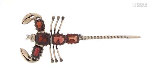 Unmarked silver and garnet scorpion brooch, 6.5cm in length, approximate weight 6.3g, housed in a