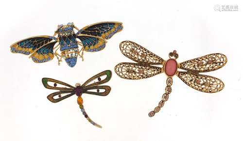 Two gilt metal enamel dragonfly brooches and a moth set with colourful stones, the largest 8cm