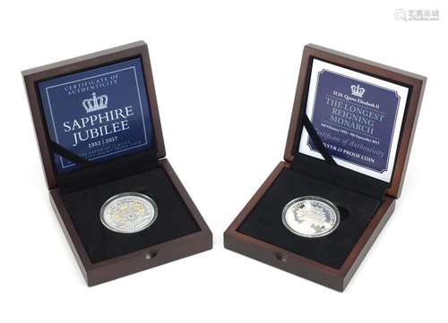 Two commemorative silver proof five pound coins, with fitted boxes comprising The Longest Reigning