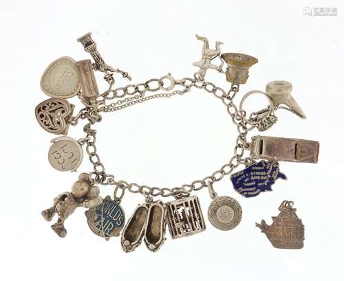 Silver charm bracelet with a selection of mostly silver charms including cancan dancers, ballet