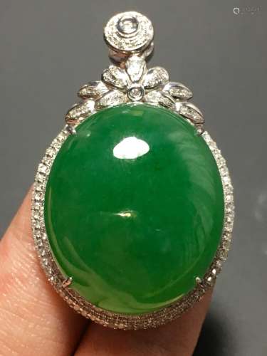 A GREEN JADEITE CARVED CIRCLE PENDANT, TYPE A