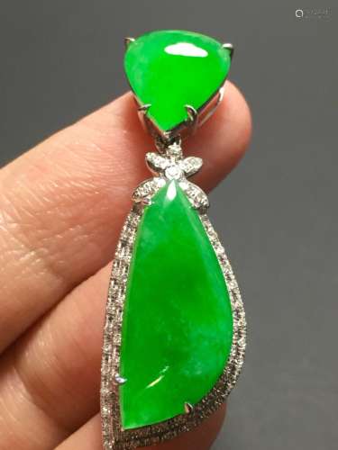 A GREEN JADEITE CARVED PENDANT, TYPE A