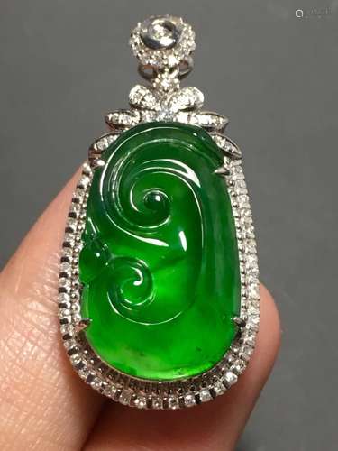 A GREEN JADEITE CARVED AUSPICIOUS PENDANT, TYPE A