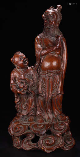 A BAMBOO CARVED FIGURE SHAPED PENDANT