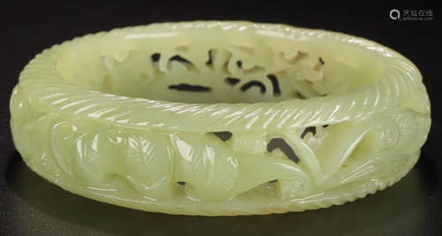 A HETIAN GREEN JADE CARVED AUSPICIOUS PATTERN BANGLE