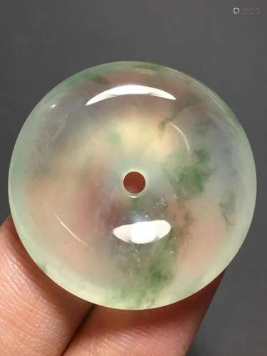 A GREEN JADEITE CARVED CIRCLE PENDANT, TYPE A