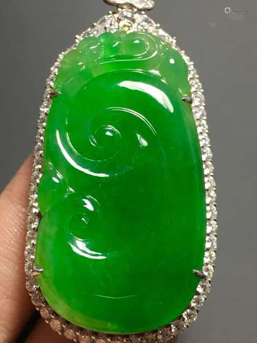 A GREEN JADEITE CARVED AUSPICIOUS PENDANT, TYPE A