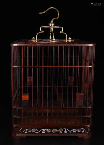 A RED WOOD CARVED SCREW DECORATED SQUARE CAGE