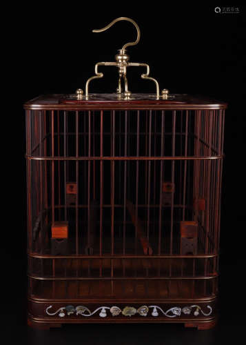 A RED WOOD CARVED SCREW DECORATED SQUARE CAGE