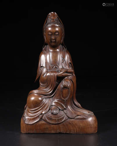 A SITTING BUDDHA FIGURE MADE OF PILGERODENDRON WOOD