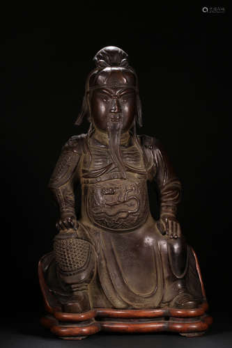 A COPPER GUANGONG BUDDHA WITH HUANGYANG WOOD BASE