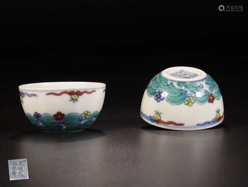 A PAIR OF PORCELAIN CUPS WITH SEA PATTERNS AND MARKING