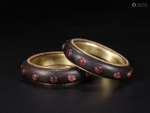 A CHENXIANG WOOD BANGLE WITH EMBEDDED TOURMALINE