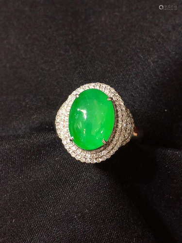 A GREEN JADEITE RING WRAPPED WITH DIAMONDS