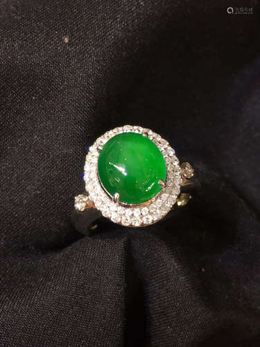 A GREEN JADEITE RING WRAPPED WITH DIAMONDS