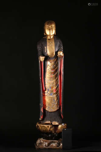 A WOOD LACQUER STANDING BUDDHA WITH GOLD OUTLINE DESIGNED