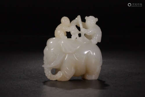 A HETIAN JADE ORNAMENT OF A CHILD WASHING AN ELEPHANT