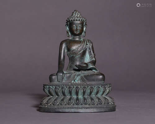 A COPPER BUDDHA SHAPED ORNAMENT