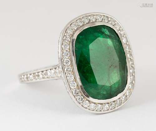 Emerald, diamond and 18k white gold ring