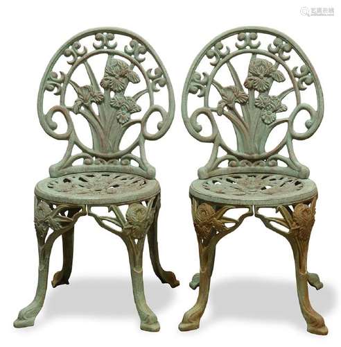 Pair of patinated cast iron garden chairs