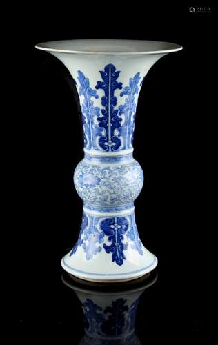 A Chinese blue & white gu vase, 19th century, with a band of scrolling lotus flanked by bands of