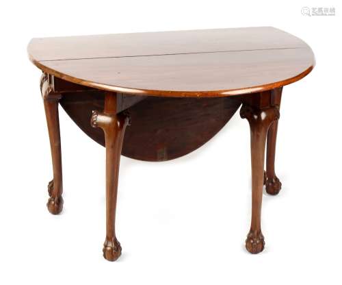 An 18th century George III Irish mahogany oval topped drop-leaf dining table with six carved
