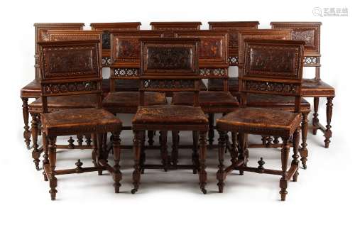 A set of twelve late 19th century French walnut & embossed leather upholstered dining chairs (12).