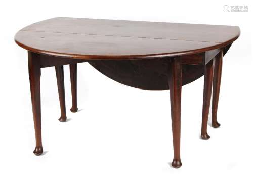 An 18th century George III Irish mahogany oval topped drop-leaf dining table with six club legs